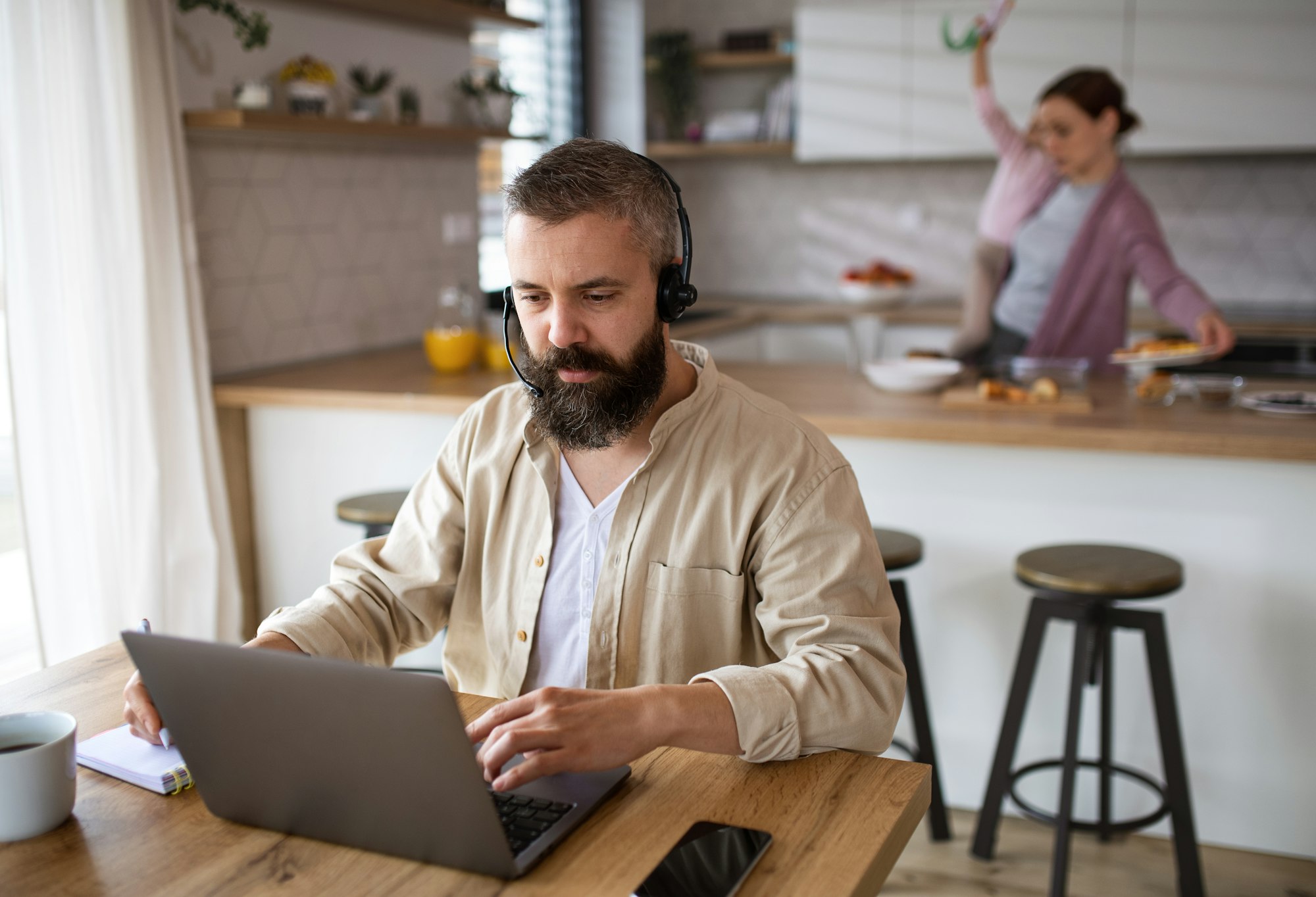 Businessman having video call indoors at home, everyday life and home office with child concept.