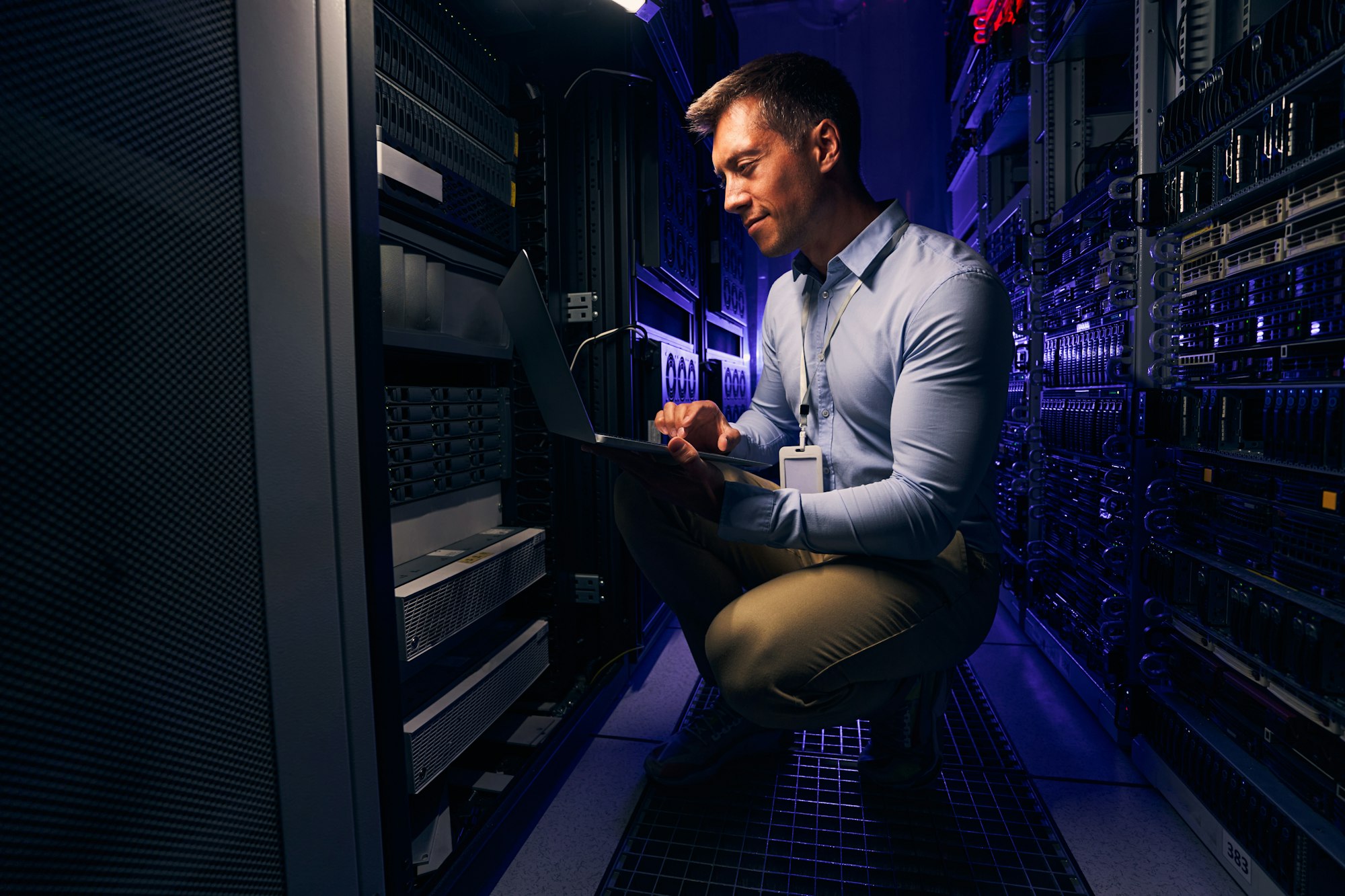 Employee checking hardware equipment in server room