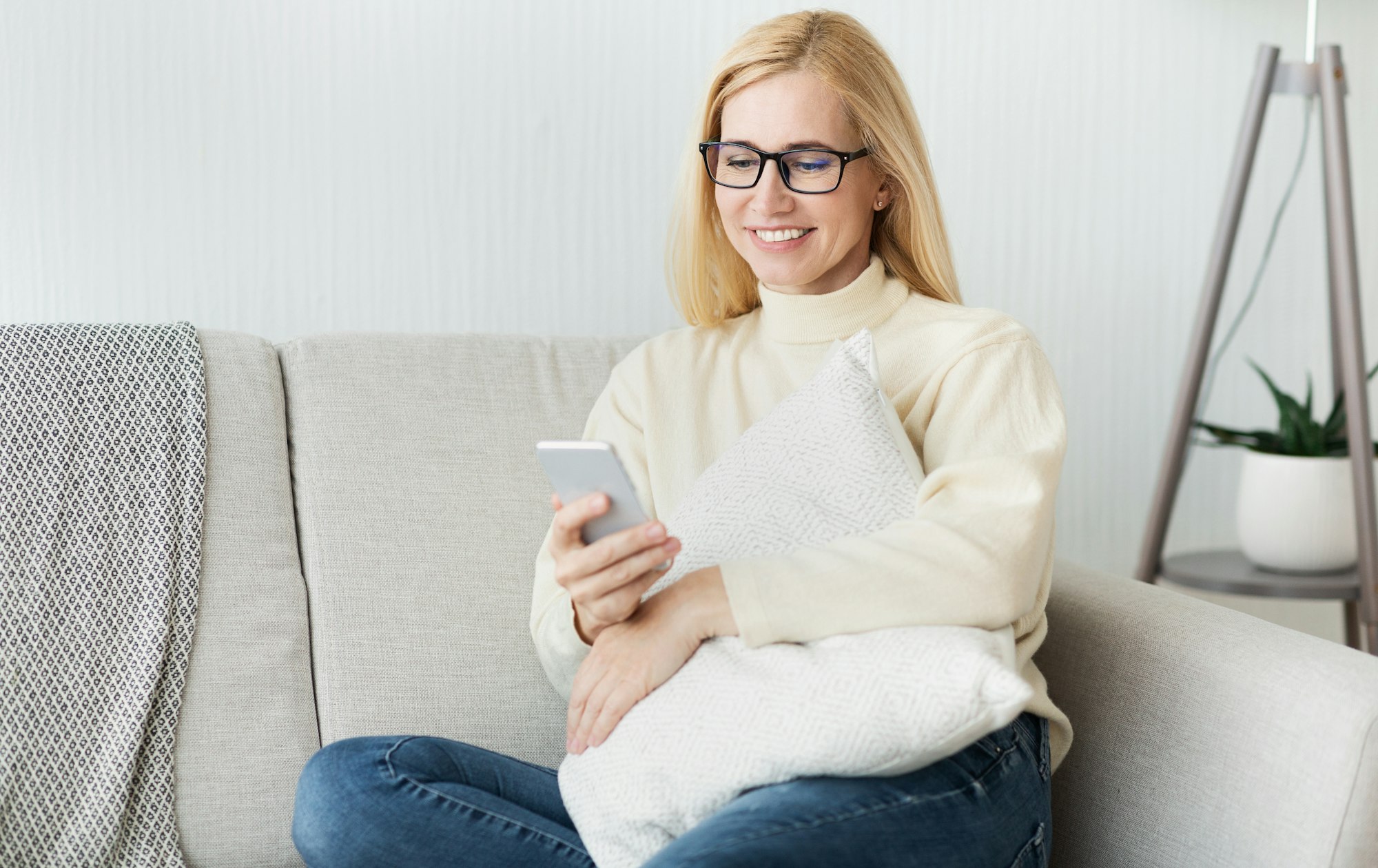 New user. Excited woman using her smartphone